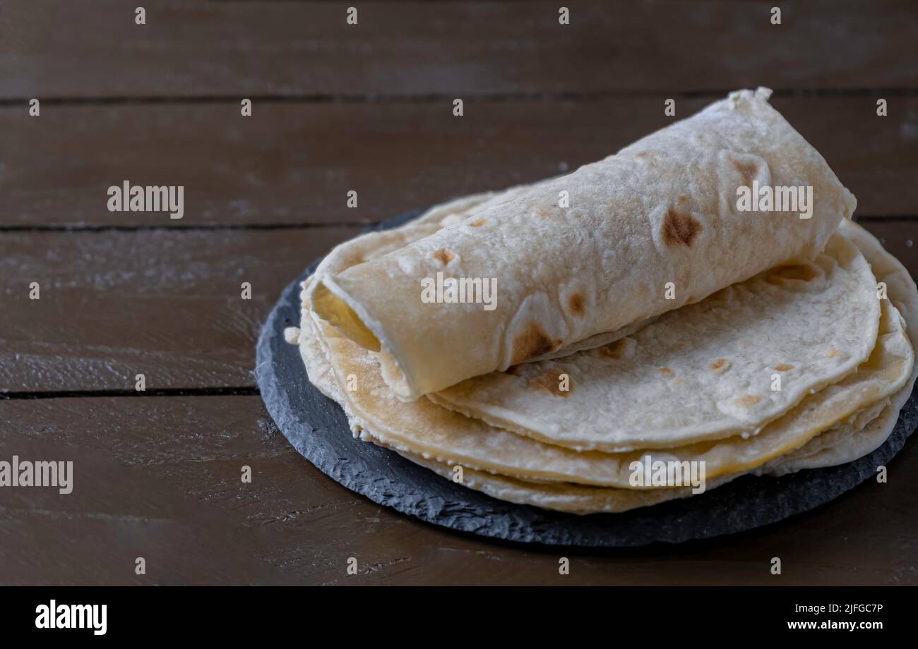 Tortillas on wooden table. Mexican bread Stock Photo