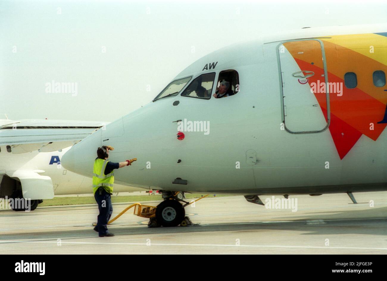 London City Airport groundcrew talking to the airplane pilot Stock Photo
