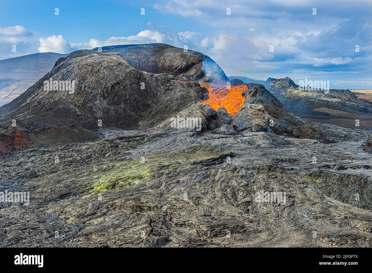 Landscape in Iceland. active volcano on the Reykjanes Peninsula. Volcanic crater with some liquid lava. Nature at day in sunshine with clouds Stock Photo