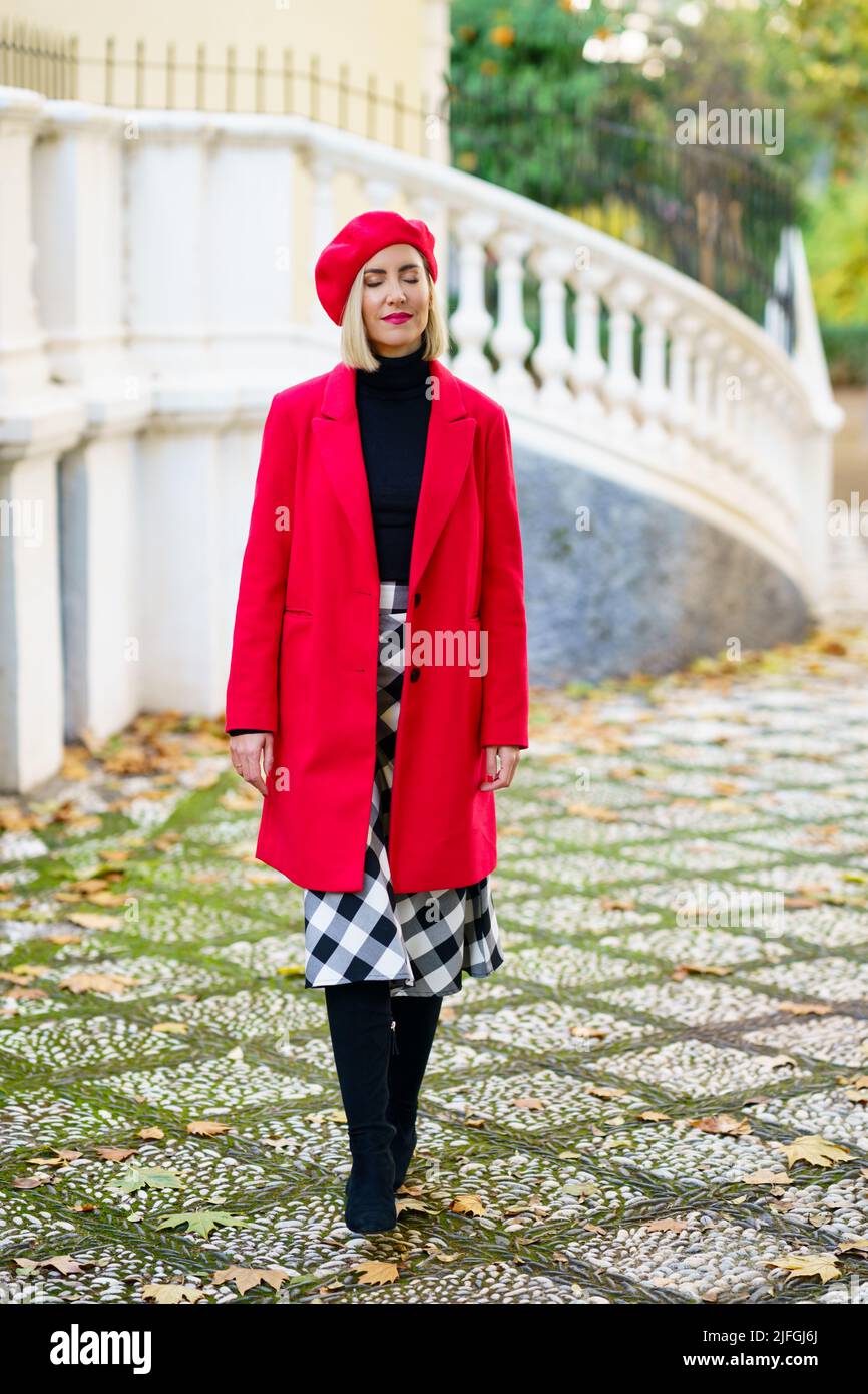 Stylish woman in red outfit on street Stock Photo