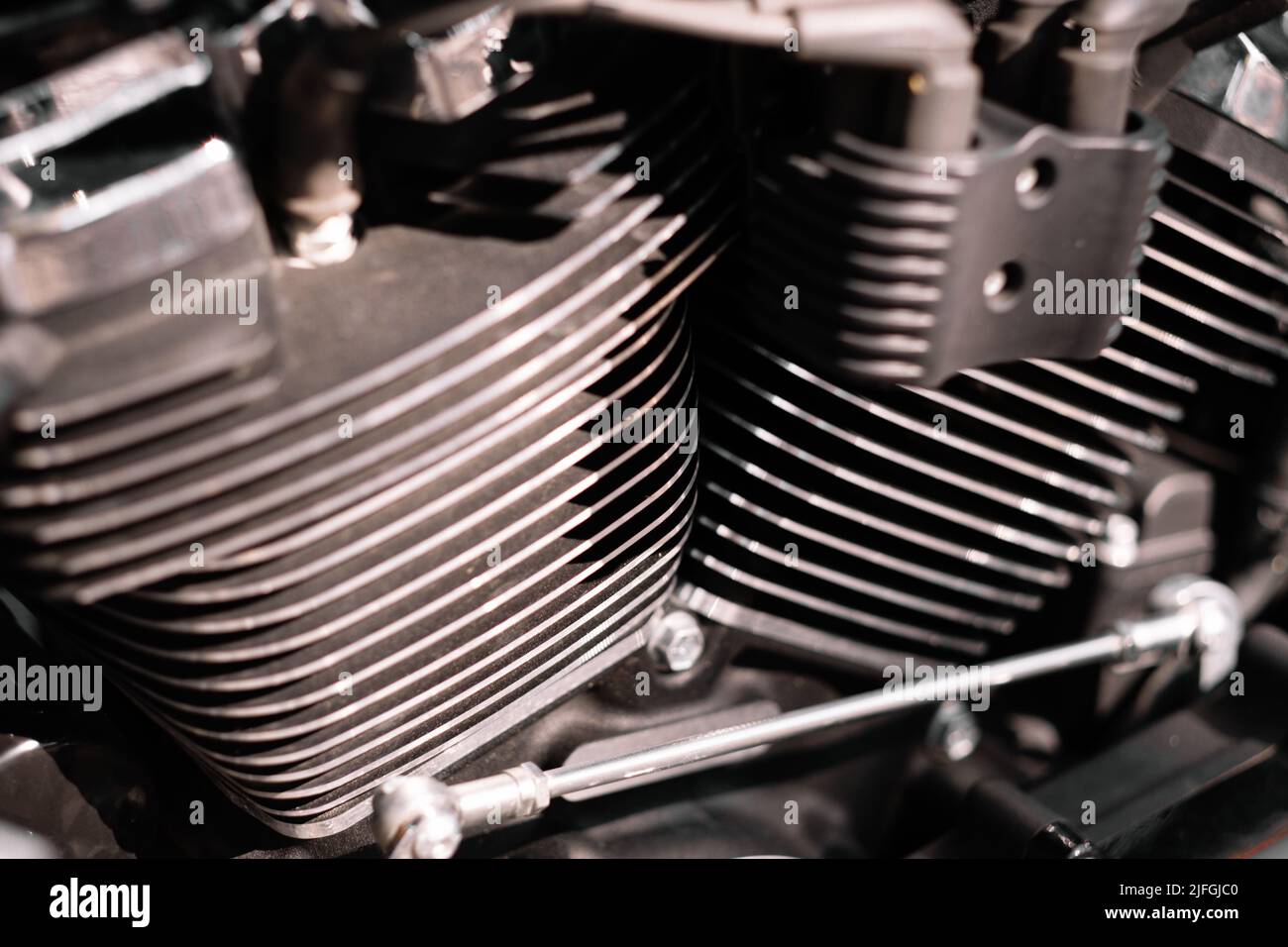 A closeup of a V-twin engine with cylinder fins of a motorcycle Stock Photo