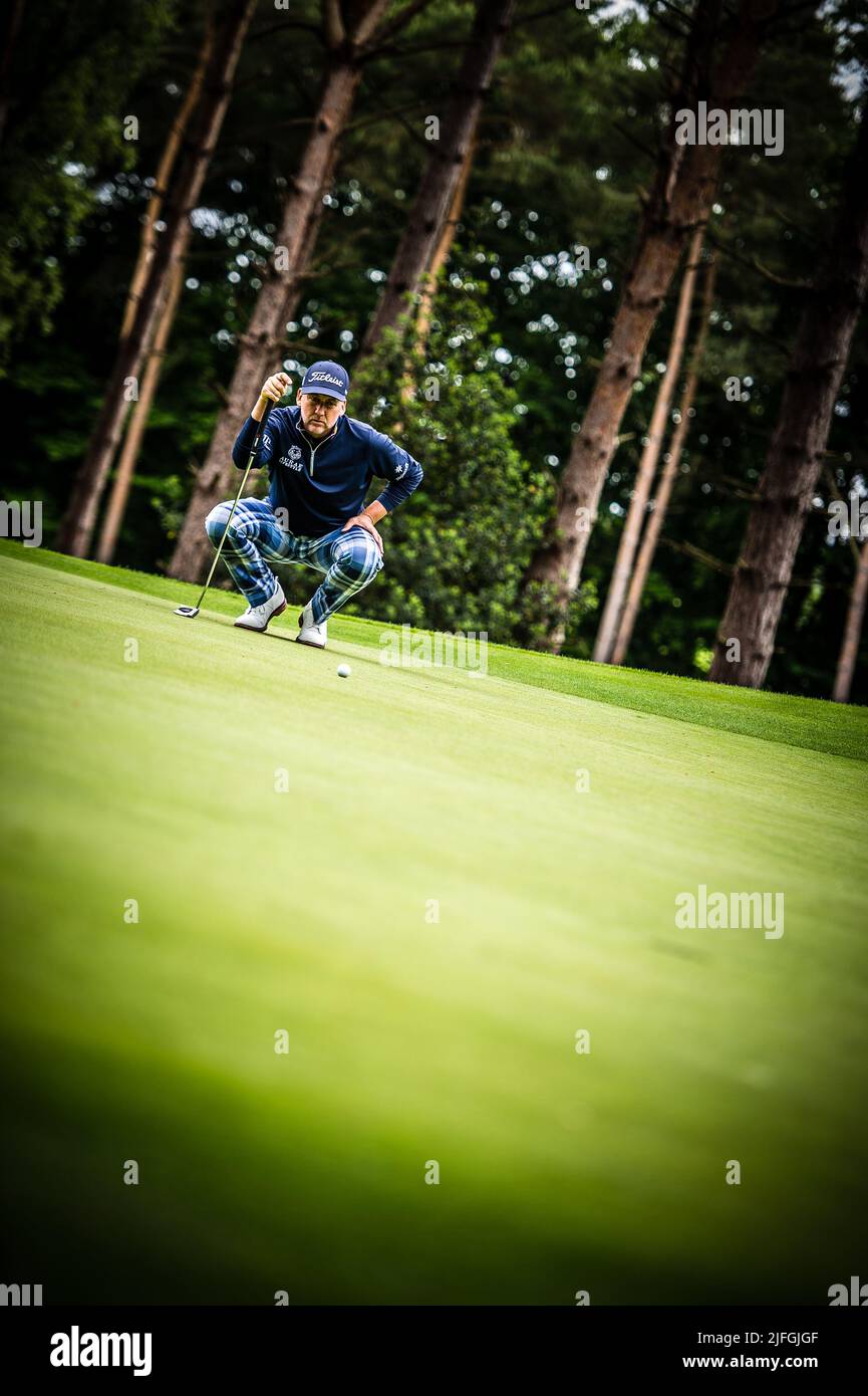 Ian Poulter checks the lay of the green before putting during the LIV Golf Invitational London Stock Photo