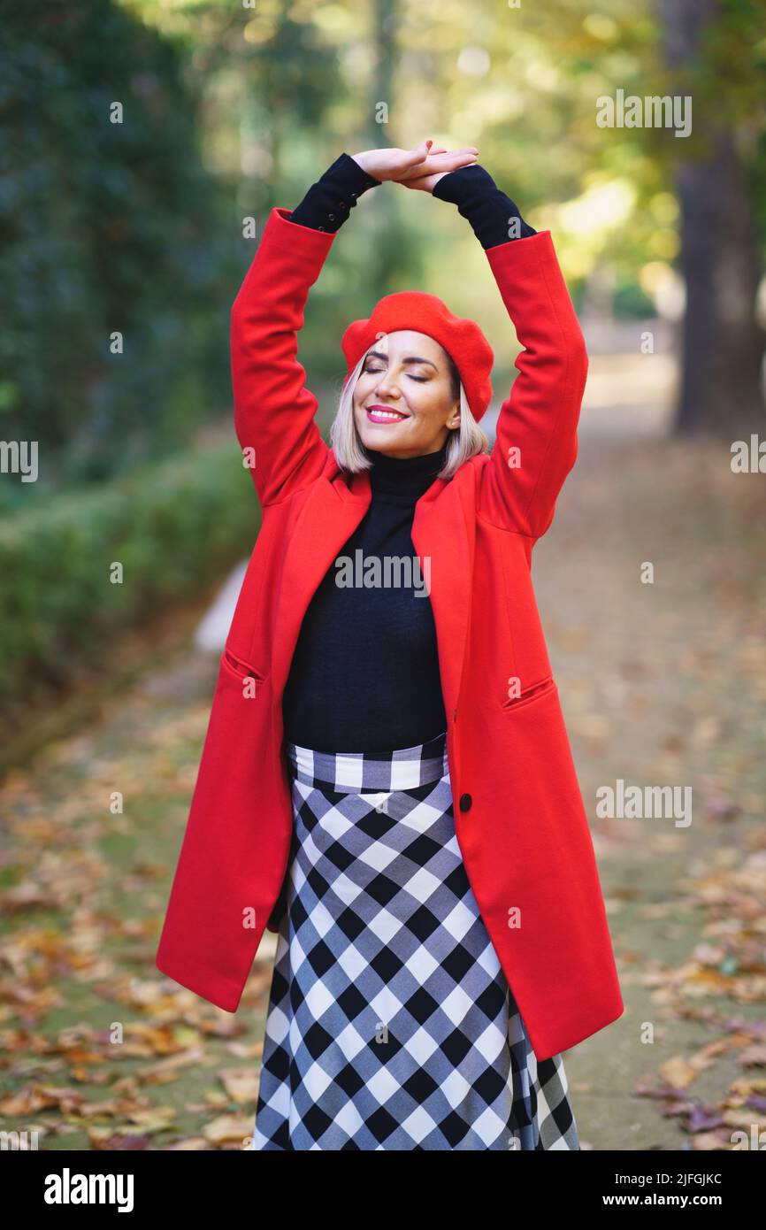 Joyful woman with raised arms in park Stock Photo - Alamy
