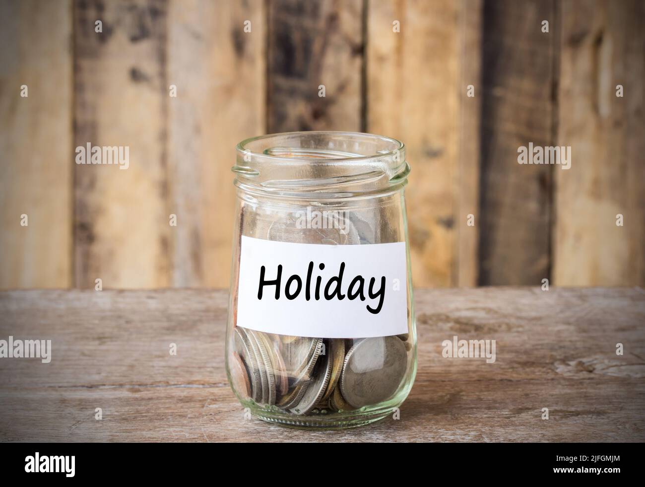 Coins in glass money jar with holiday label, financial concept. Vintage ...