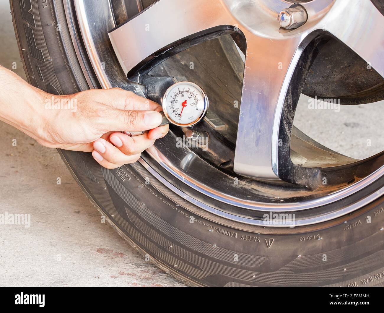 Hand holding pressure gauge for car tyre pressure measurement Stock ...