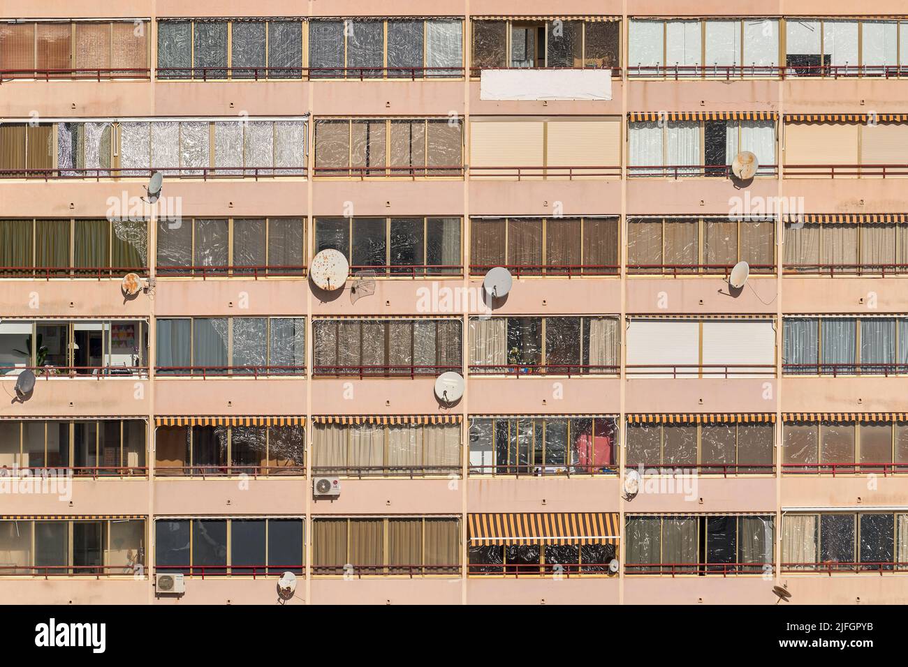 Apartment facade of a building in the first line of the Poniente beach with the reflection of the waves of the sea shore in the windows in Benidorm. Stock Photo