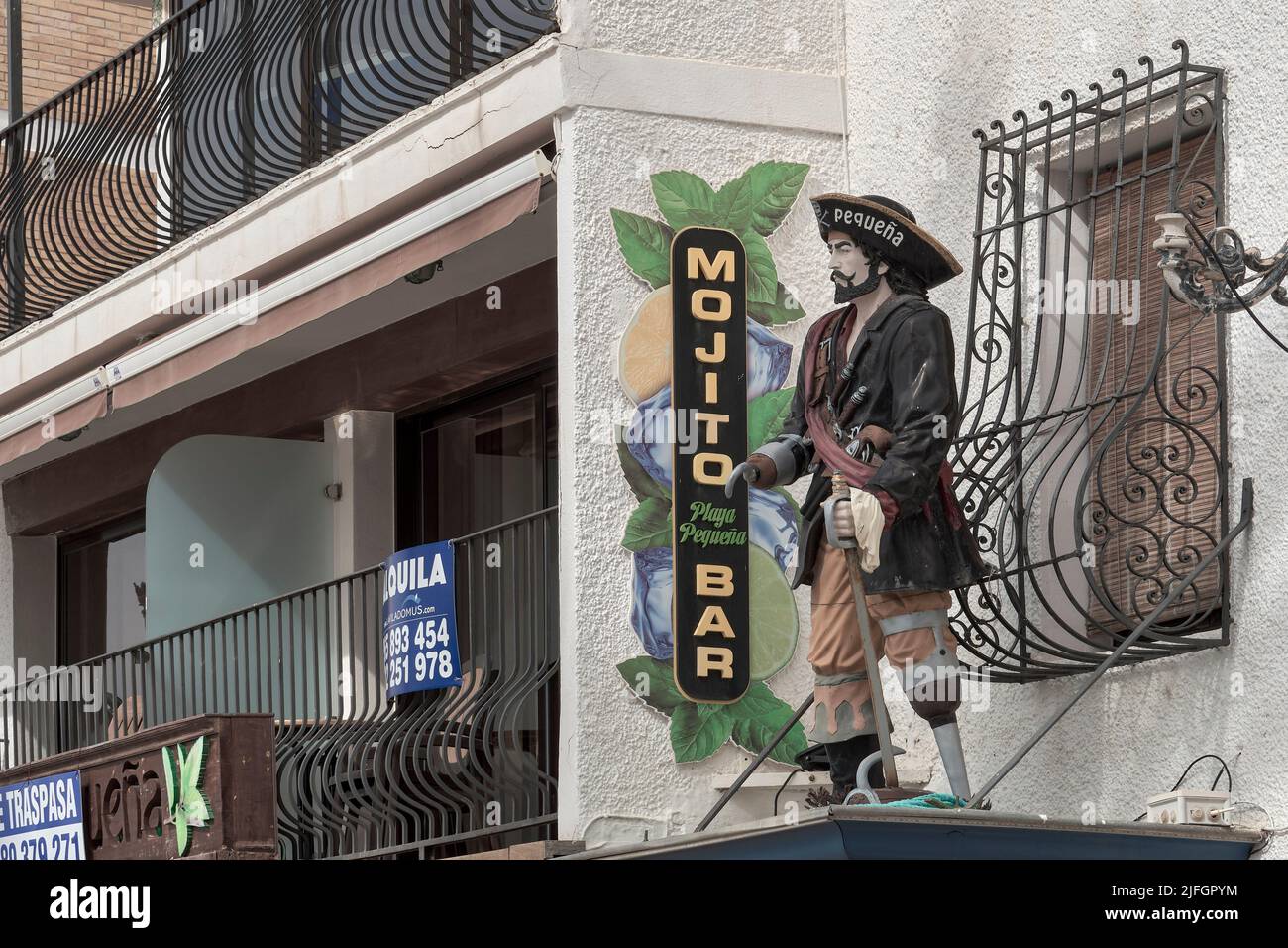 Mojito bar sign with a pirate mannequin with a wooden leg on the facade of a building on the small beach in the city of Benidorm, Alicante, Spain Stock Photo