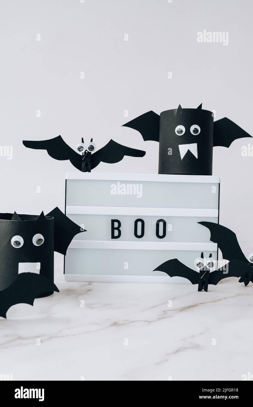 Lightbox with text BOO around paper bats. Halloween party ...