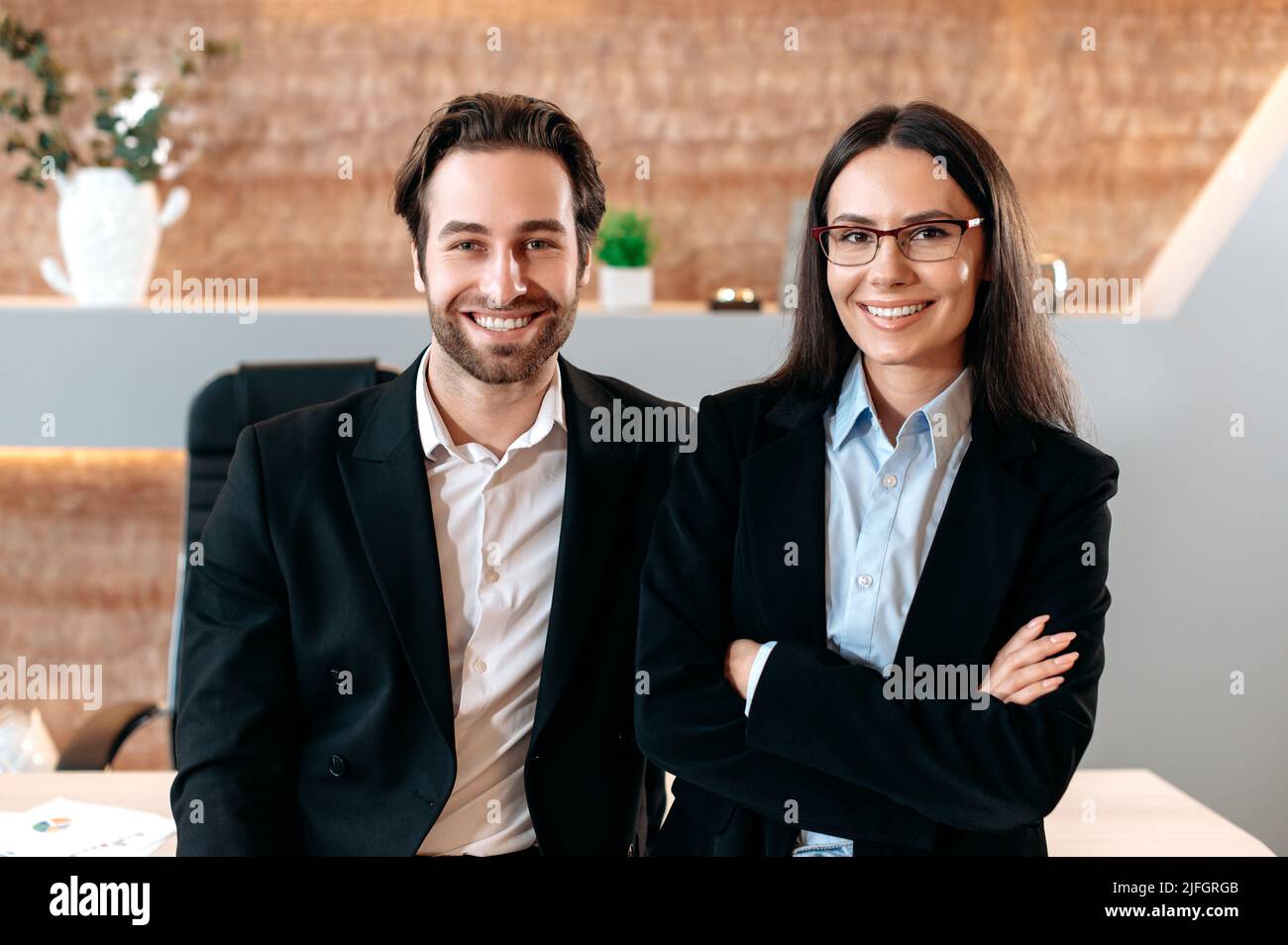 Portrait of two successful caucasian business partners, a man and a