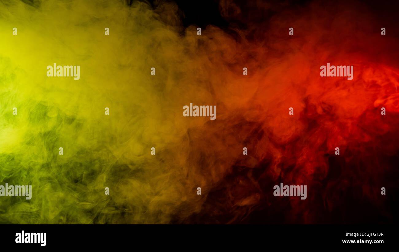 Red-yellow smoke spreads on a black background Stock Photo - Alamy