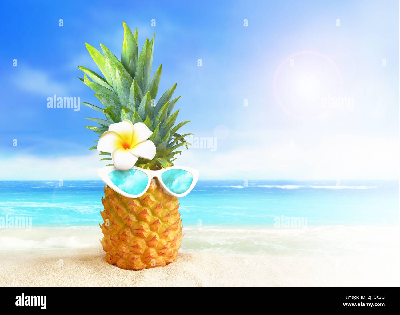 Pineapple with sunglasses on tropical beach background. Summer concept