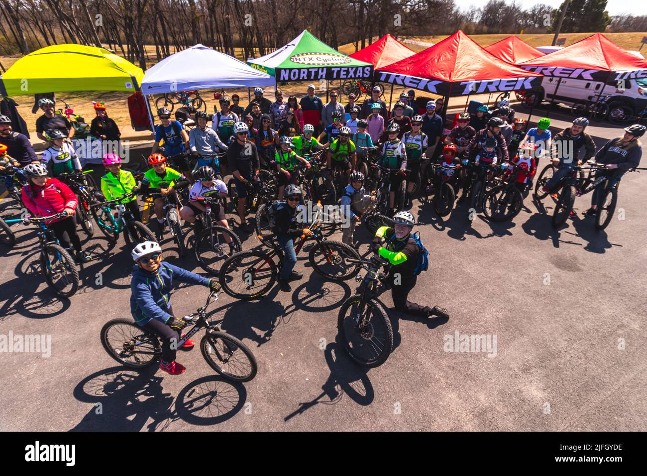 A high angle of Caucasian people getting ready to ride a bike in a race held in the DFW metroplex Stock Photo