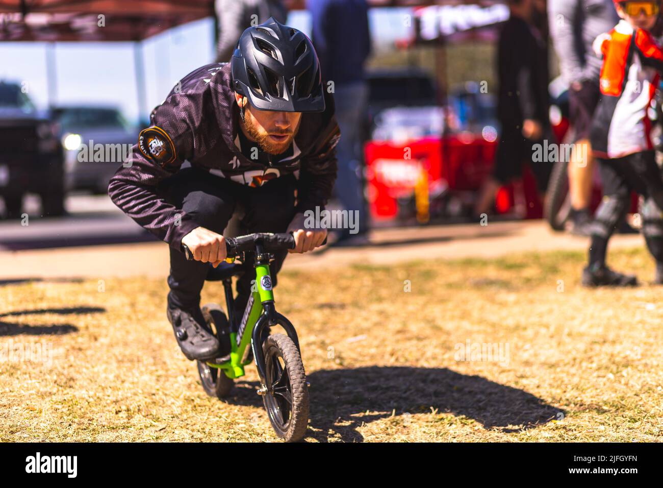 A Caucasian man sitting on a mini bike during the DFW metroplex race in Texas Stock Photo