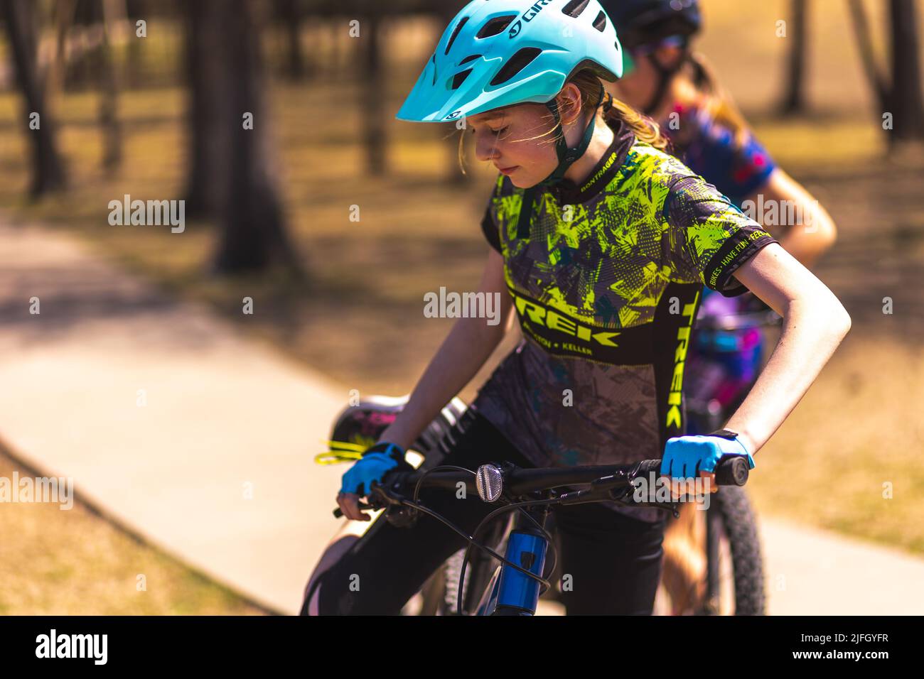 A Caucasian girl riding a bike in a race held in the DFW metroplex in Texas Stock Photo