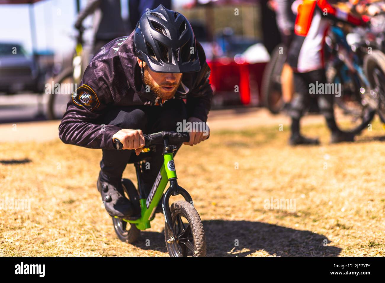 A Caucasian man sitting on a mini bike during the DFW metroplex race in Texas Stock Photo