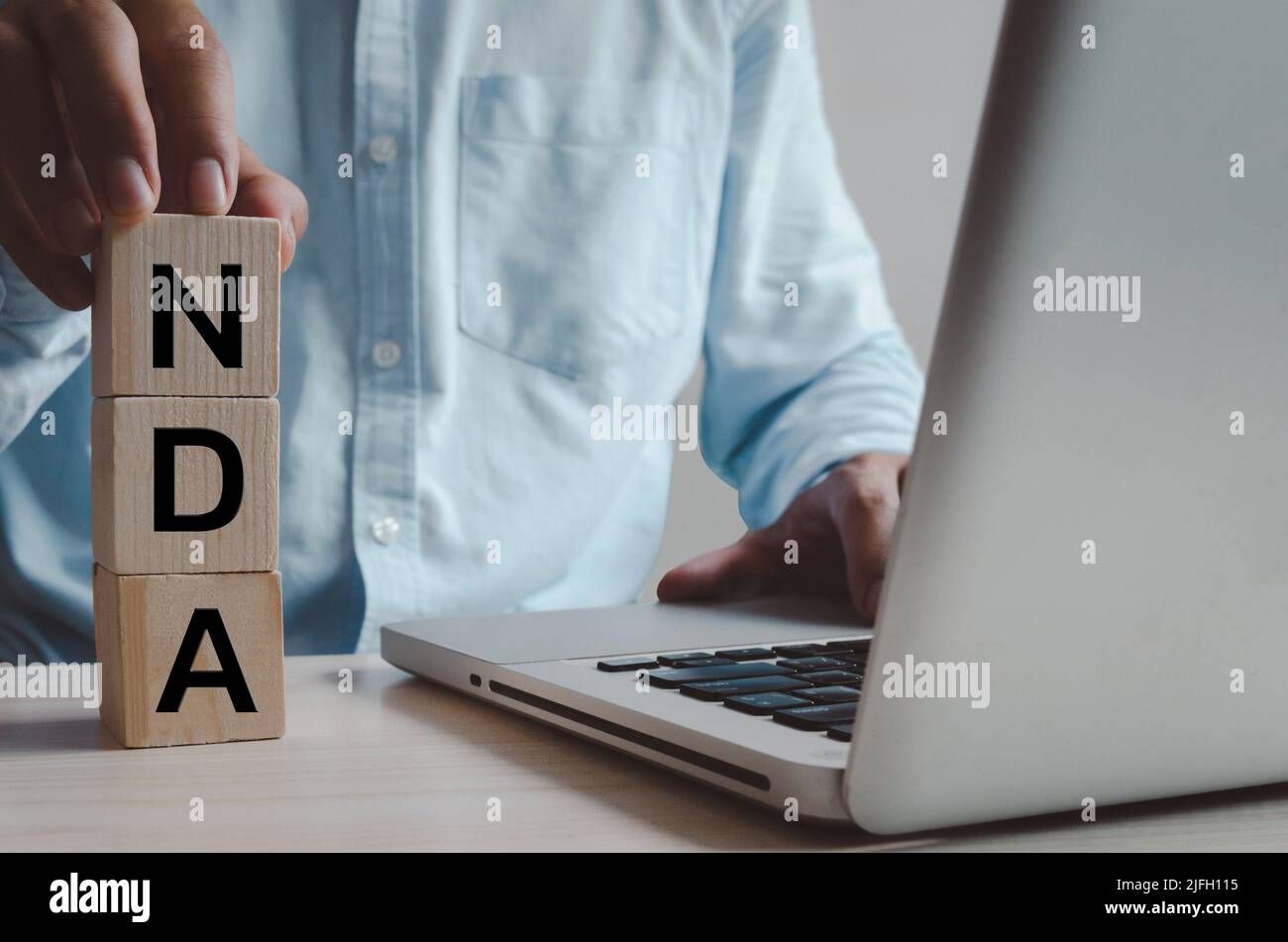 Wooden cubes with NDA Non disclosure Agreement symbol on background and ...