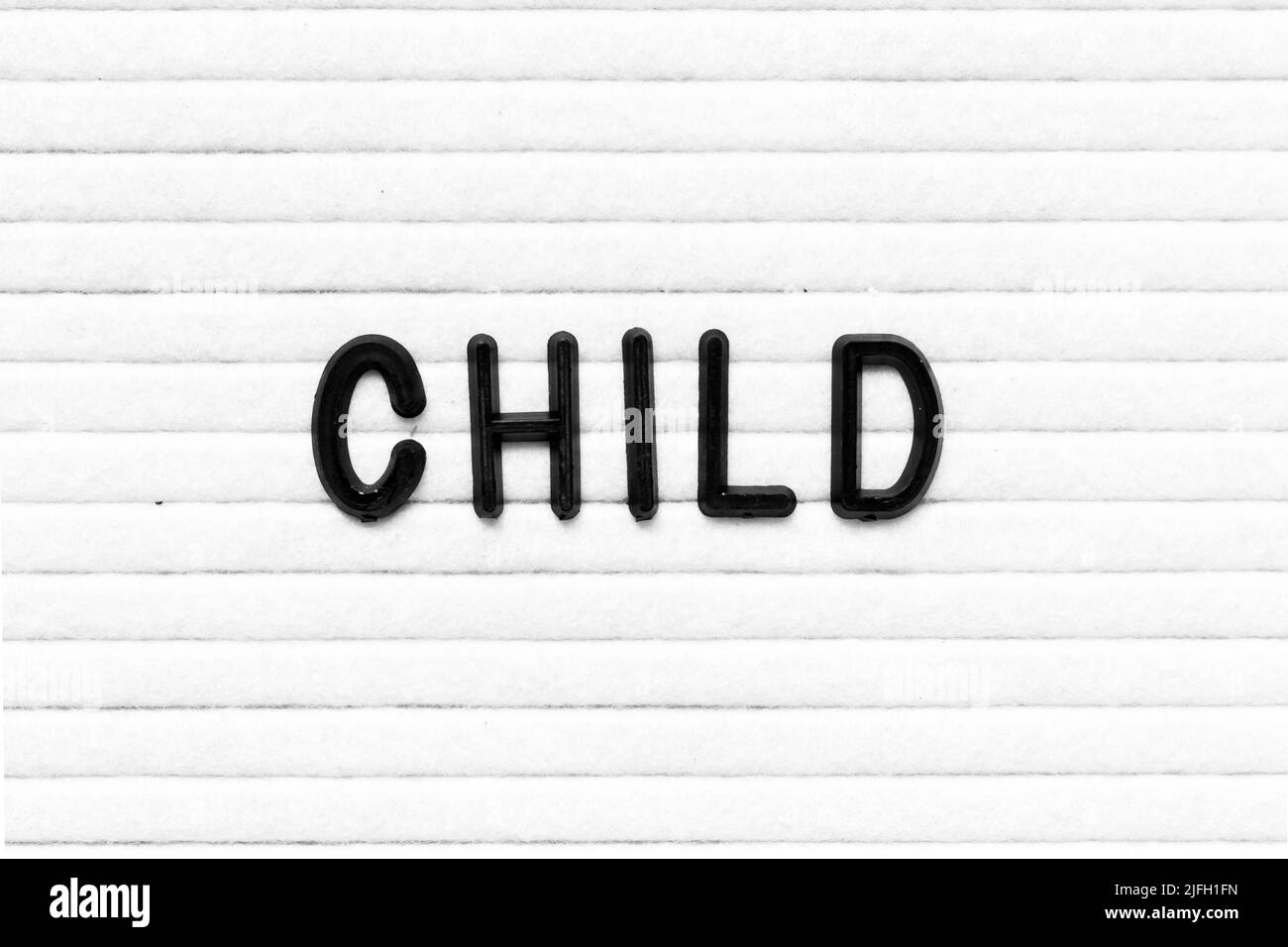 Black color letter in word child on white felt board background Stock