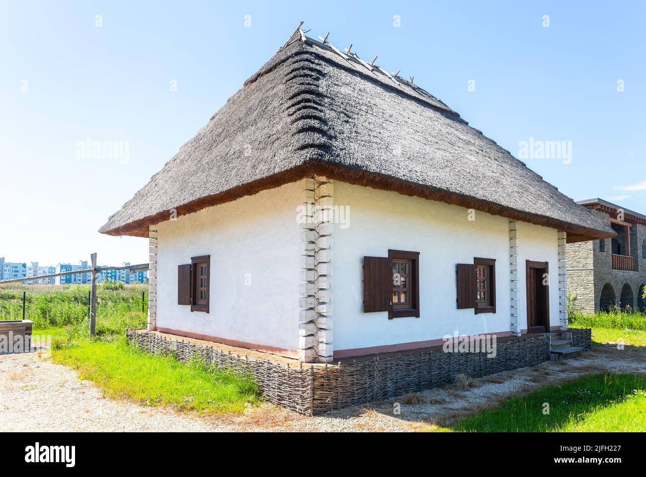 Samara, Russia - June 25, 2022: Ethnocultural complex 'People's Friendship Park'. Traditional Ukrainian house with thatched roof. National Ukrainian h Stock Photo