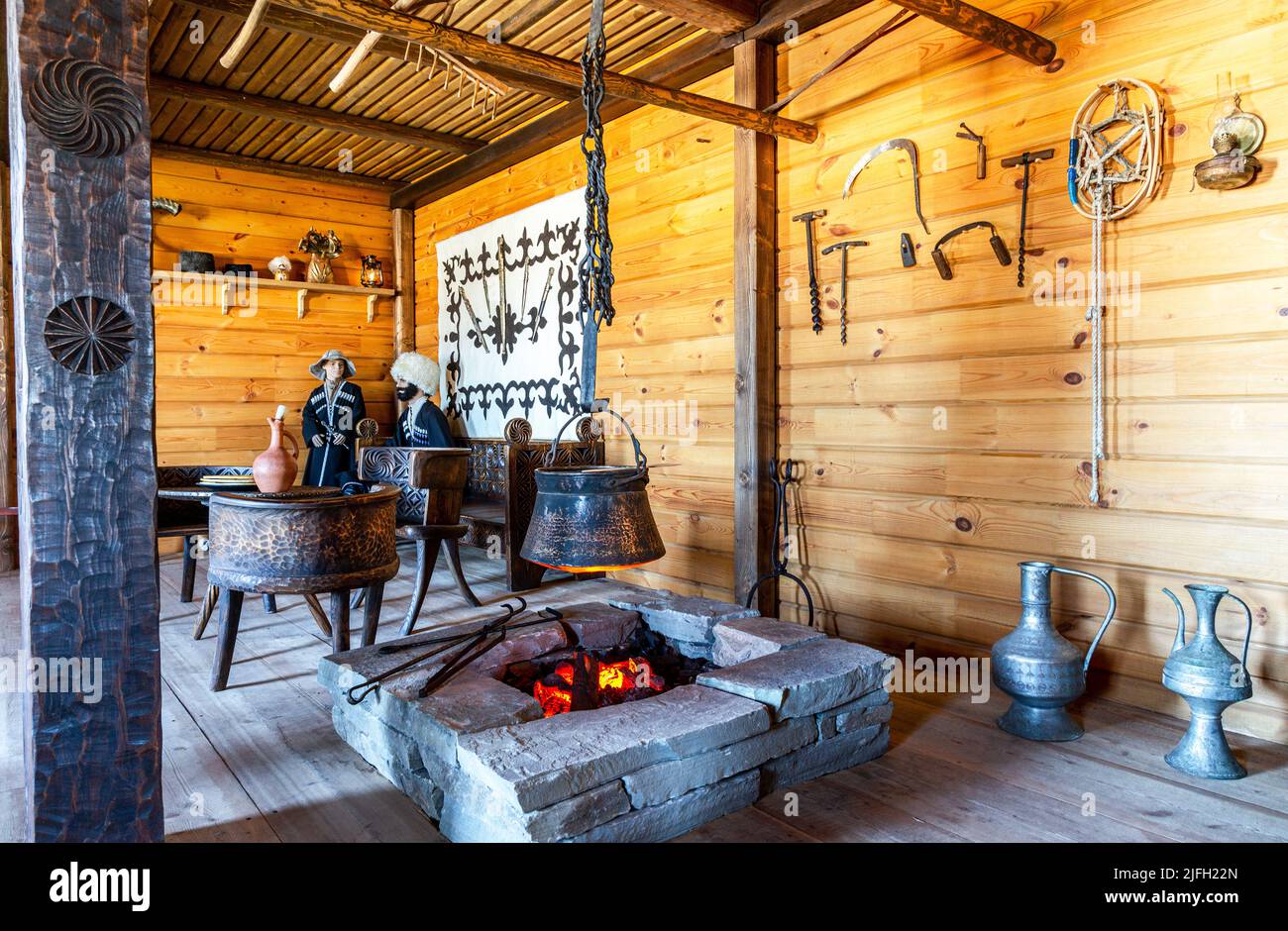 Samara, Russia - June 25, 2022: Ethnocultural complex 'People's Friendship Park'. Interior of the traditional Osetinian house from wooden logs and sto Stock Photo