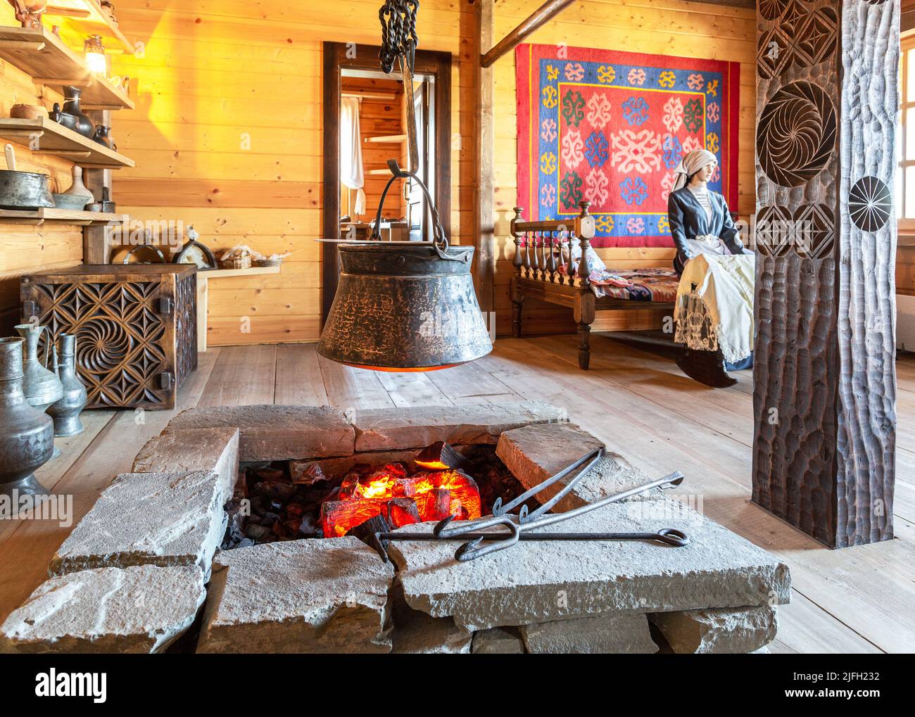 Samara, Russia - June 25, 2022: Ethnocultural complex 'People's Friendship Park'. Interior of the traditional Osetinian house from wooden logs and sto Stock Photo