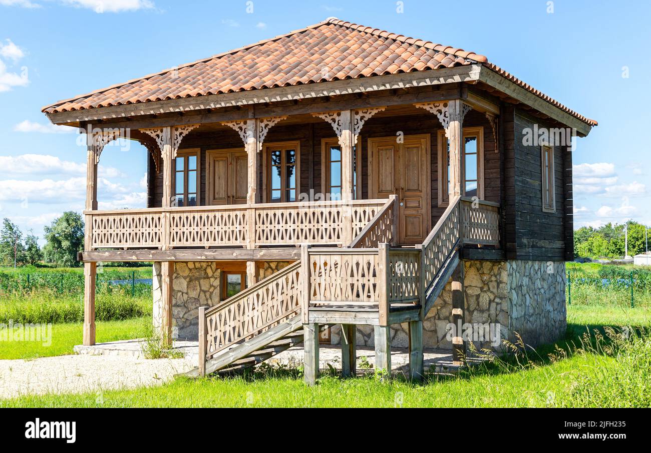 Samara, Russia - June 25, 2022: Ethnocultural complex 'People's Friendship Park'. Traditional Georgian house from wooden logs and stones. Georgian hou Stock Photo