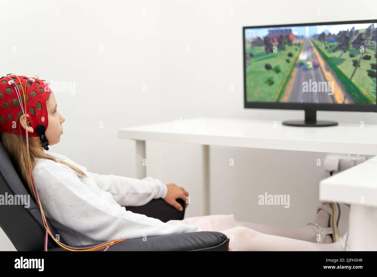 Girl with headgear to monitoring the brain activity during a
