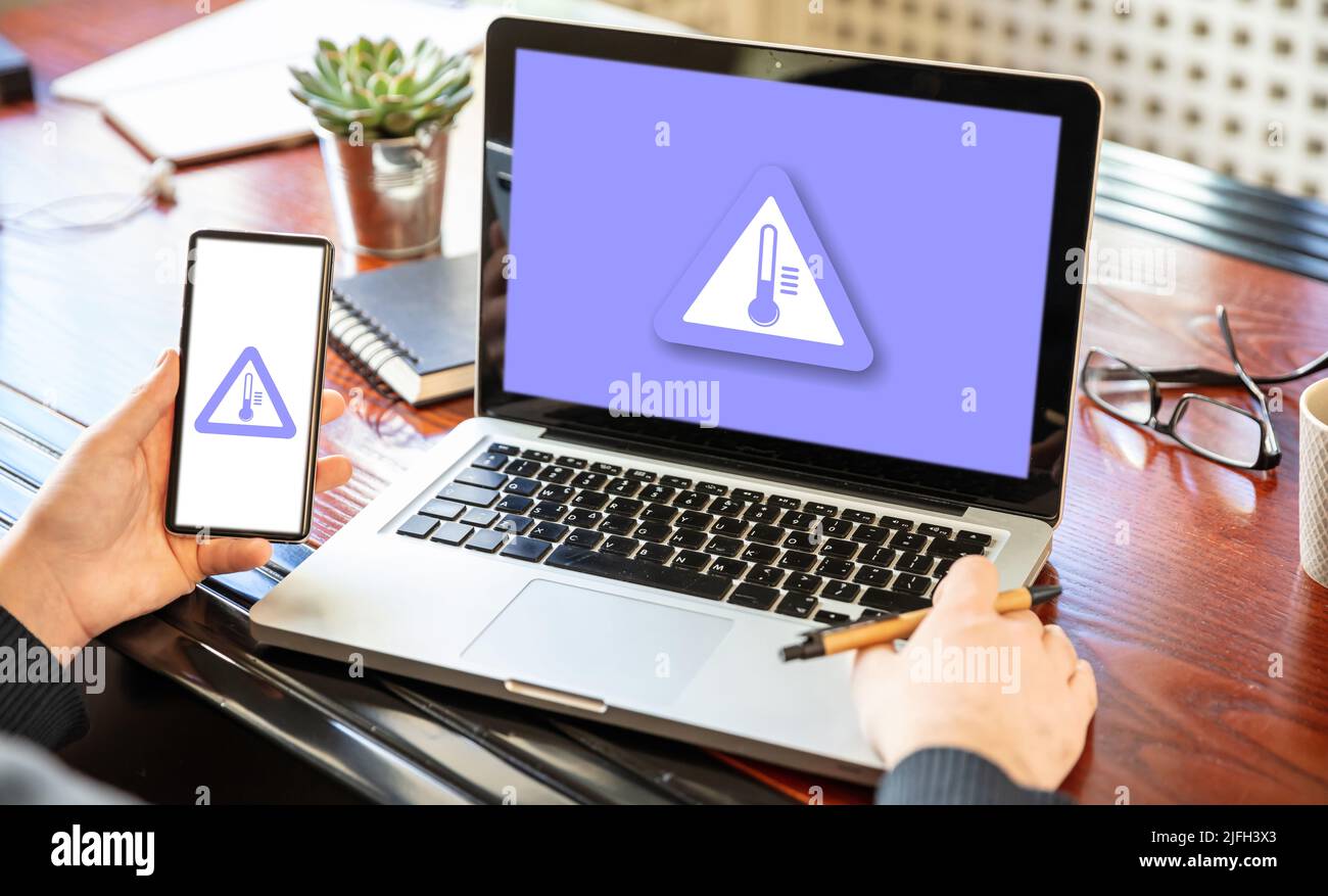 High temperature warning sign on a computer and mobile screen. PC