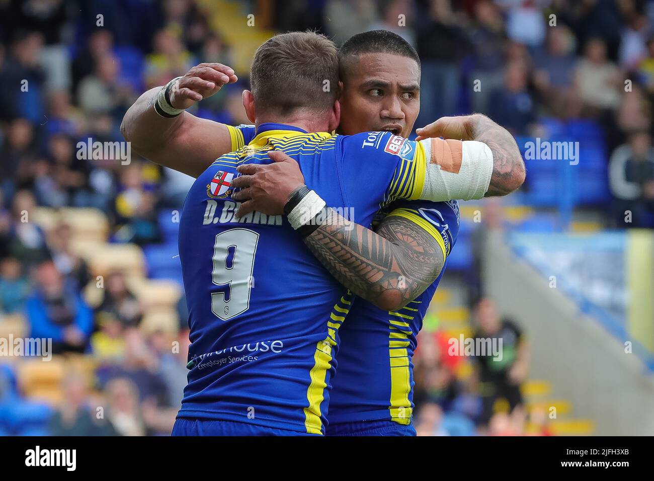 Daryl Clark #9 of Warrington Wolves celebrates his try with Peter Mata