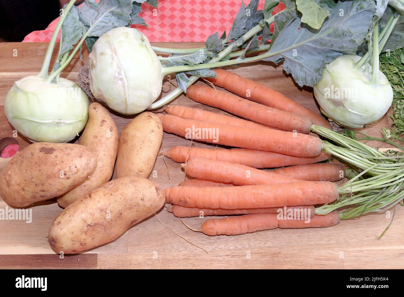 Harvest fresh, vegetables from the home garden: potatoes, swede, turnip, (Kohlrabi) and carrots. Stock Photo