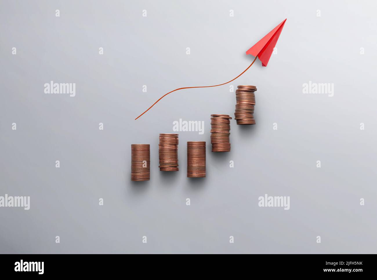 Increasing inflation, costs and prices concept, business chart stacks of coins with paper airplane moving upwards Stock Photo