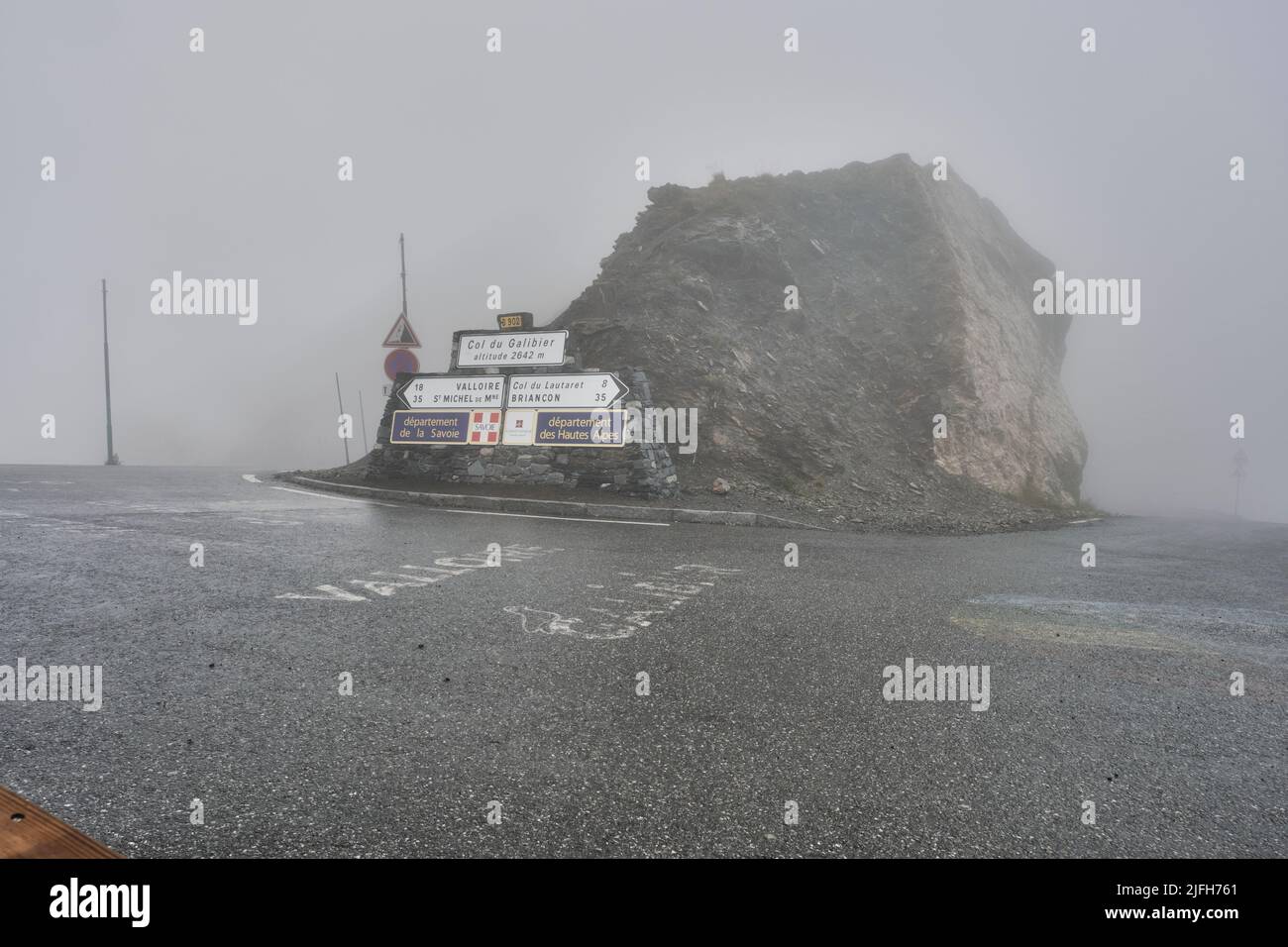 Road sign of Col de Galibier in the mist, stage on the tour de france in the french alps Stock Photo