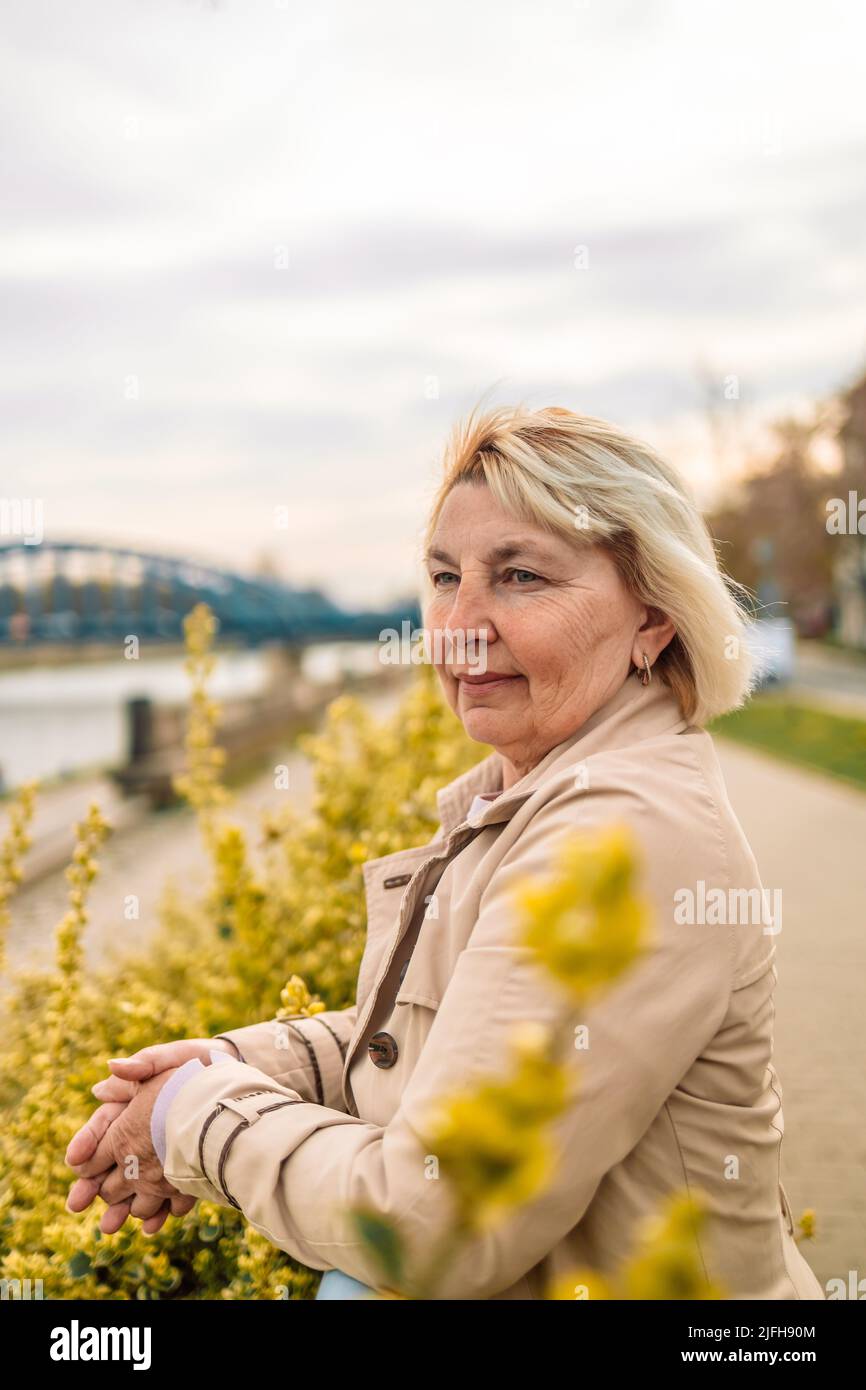 A happy 60 Year old blond woman and a 66 year old man smiling at the  camera, outdoors, Stock Photo, Picture And Rights Managed Image. Pic.  E94-3371079