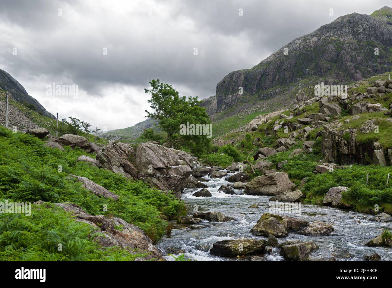 Afon Nant Peris is a river flowing through the Llanberis Pass in Snowdonia, Wales between the Glyderau and Snowdon massifs. Stock Photo