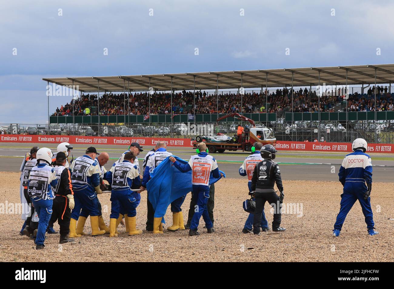Silverstone, UK. 3rd July 2022, Silverstone Circuit, Silverstone, Northamptonshire, England: British F1 Grand Prix, Race day: Alfa Romeo F1 Team Orlen, Guanyu Zhou is taken away by doctors Credit: Action Plus Sports Images/Alamy Live News Stock Photo