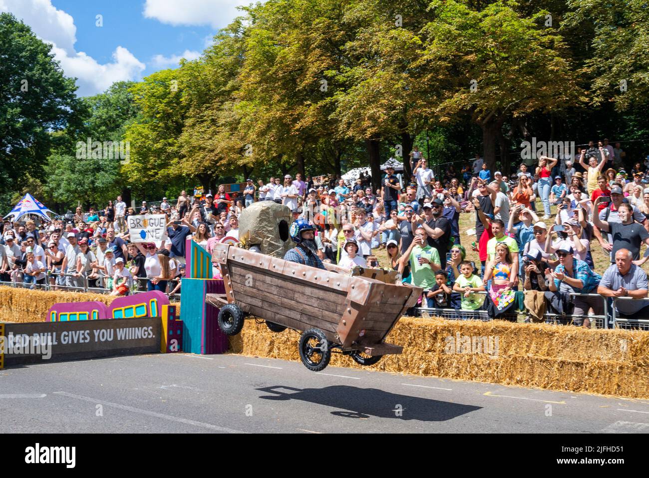 Alexandra Palace, London, UK. 3rd Jul, 2022. Weird and wacky soapbox designs raced down the hill course through Alexandra Park below ‘Ally Pally’ and over jumps that tested the designs and driving abilities of the teams. Around 70 hand-made carts powered purely by gravity and a push from the crews from the top of the hill attempted to set the fastest time. Many came to grief before the finish line. Team Goldrush kart jumping Stock Photo