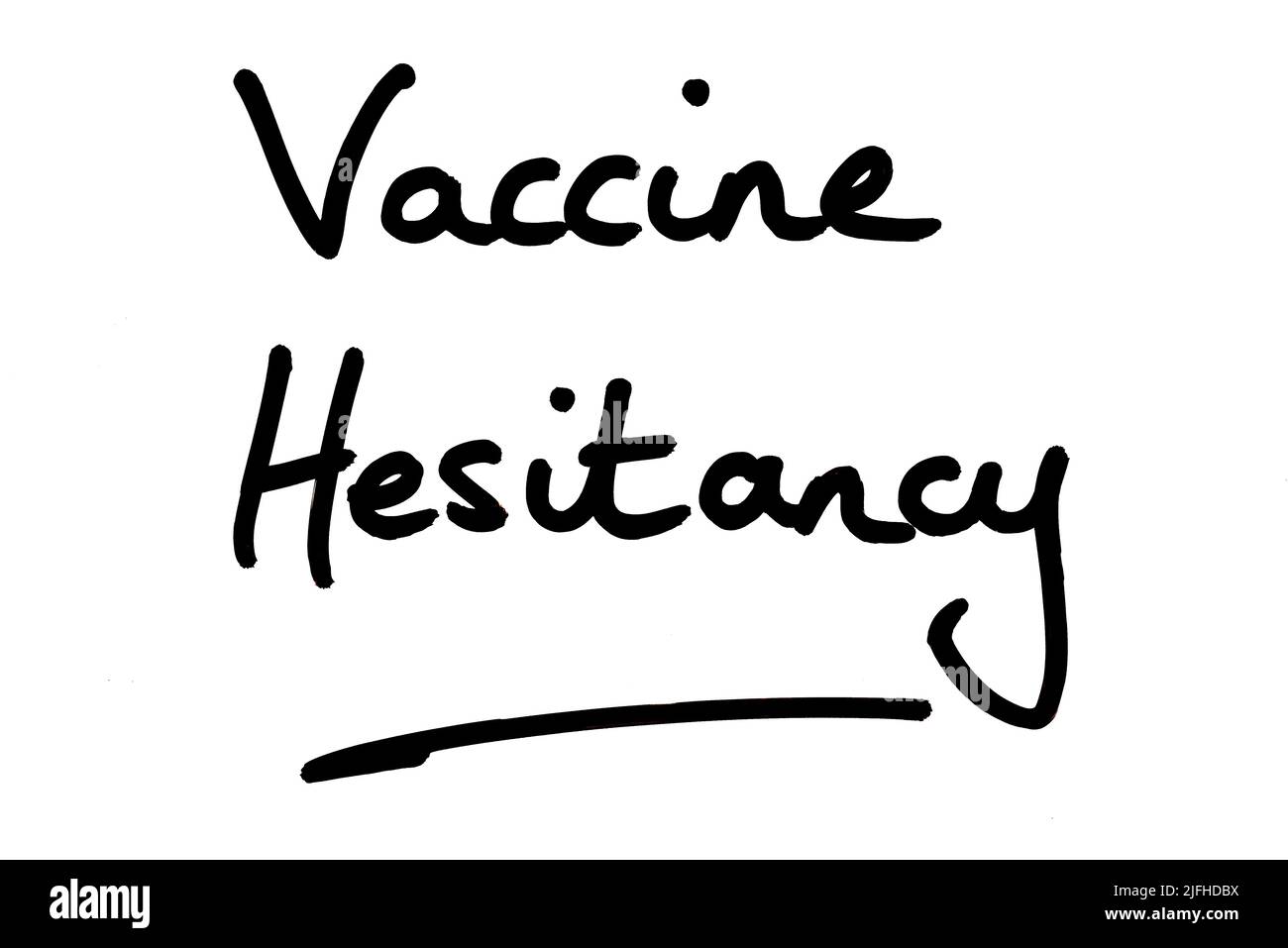 Vaccine Hesitancy, handwritten on a white background. Stock Photo