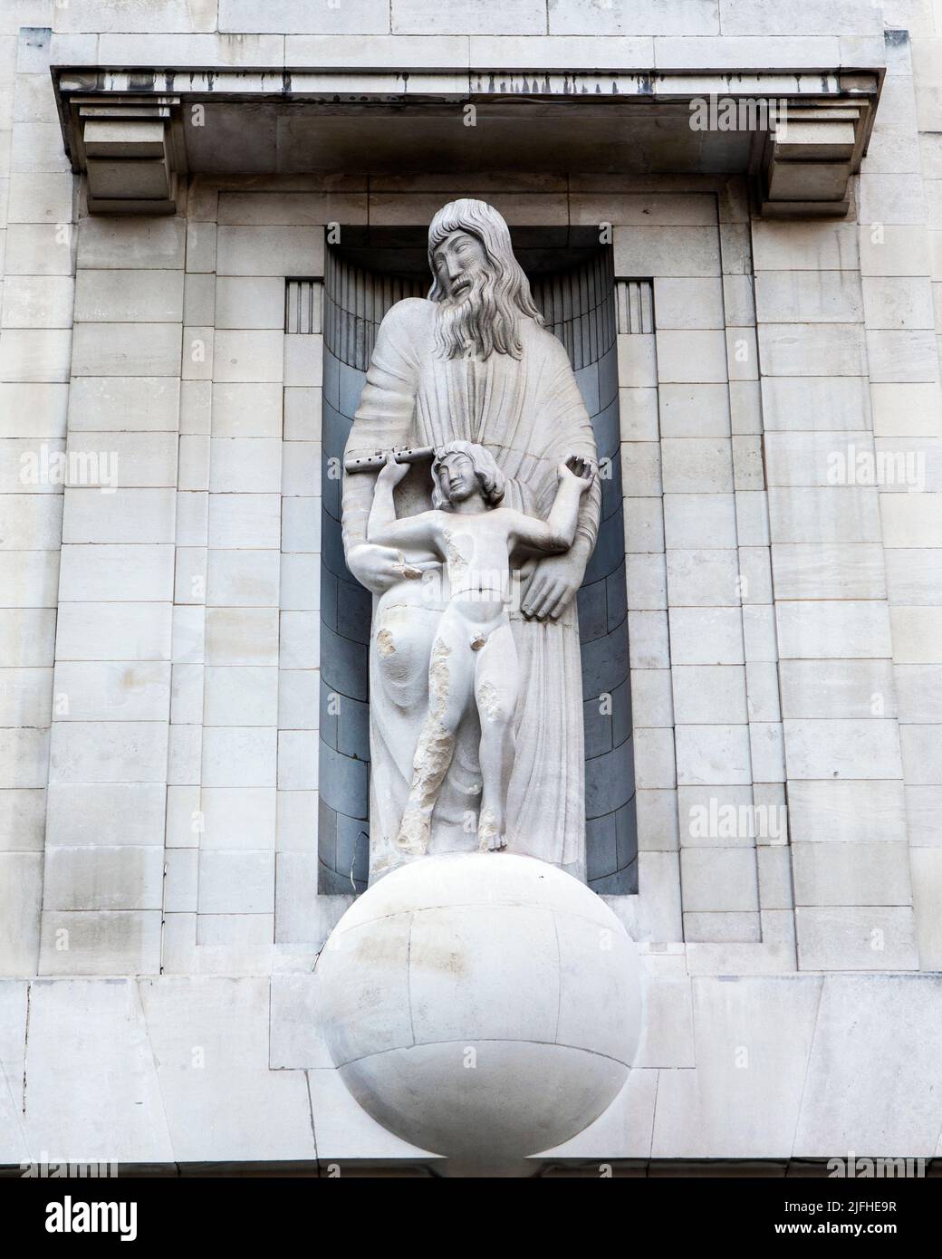 The sculpture on the exterior of the BBC headquarters, located on Portland Place and Langham Place in London, UK. The statue by Eric Gill has sparked Stock Photo