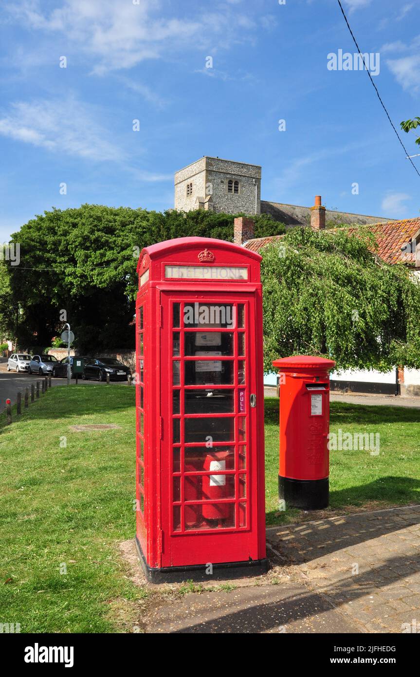 Village centre with telephone box, post box and church, Thornham, Norfolk, England, UK Stock Photo