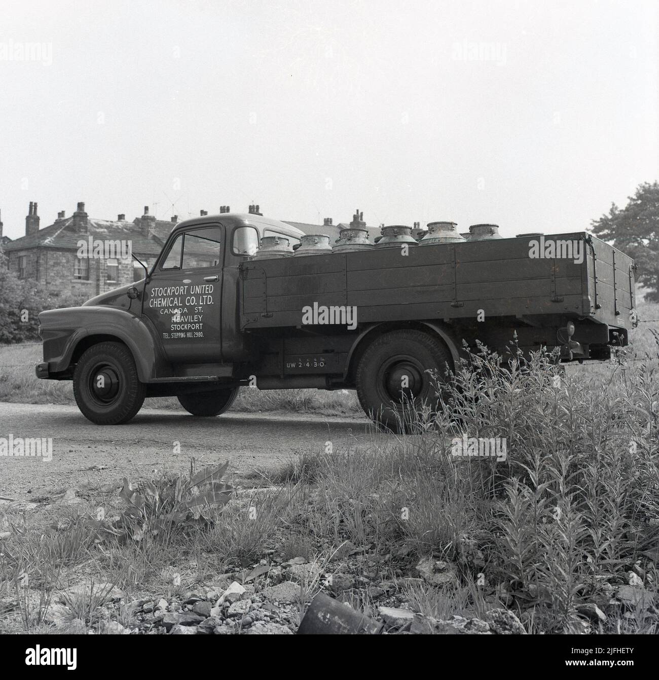 1950s, historical, side view of a Bedford TJ delivery truck of the Stockport United Chemical Company of Canada St, Heaviley, Stockport, England, UK, with a load steel containers in the open rear. Stock Photo