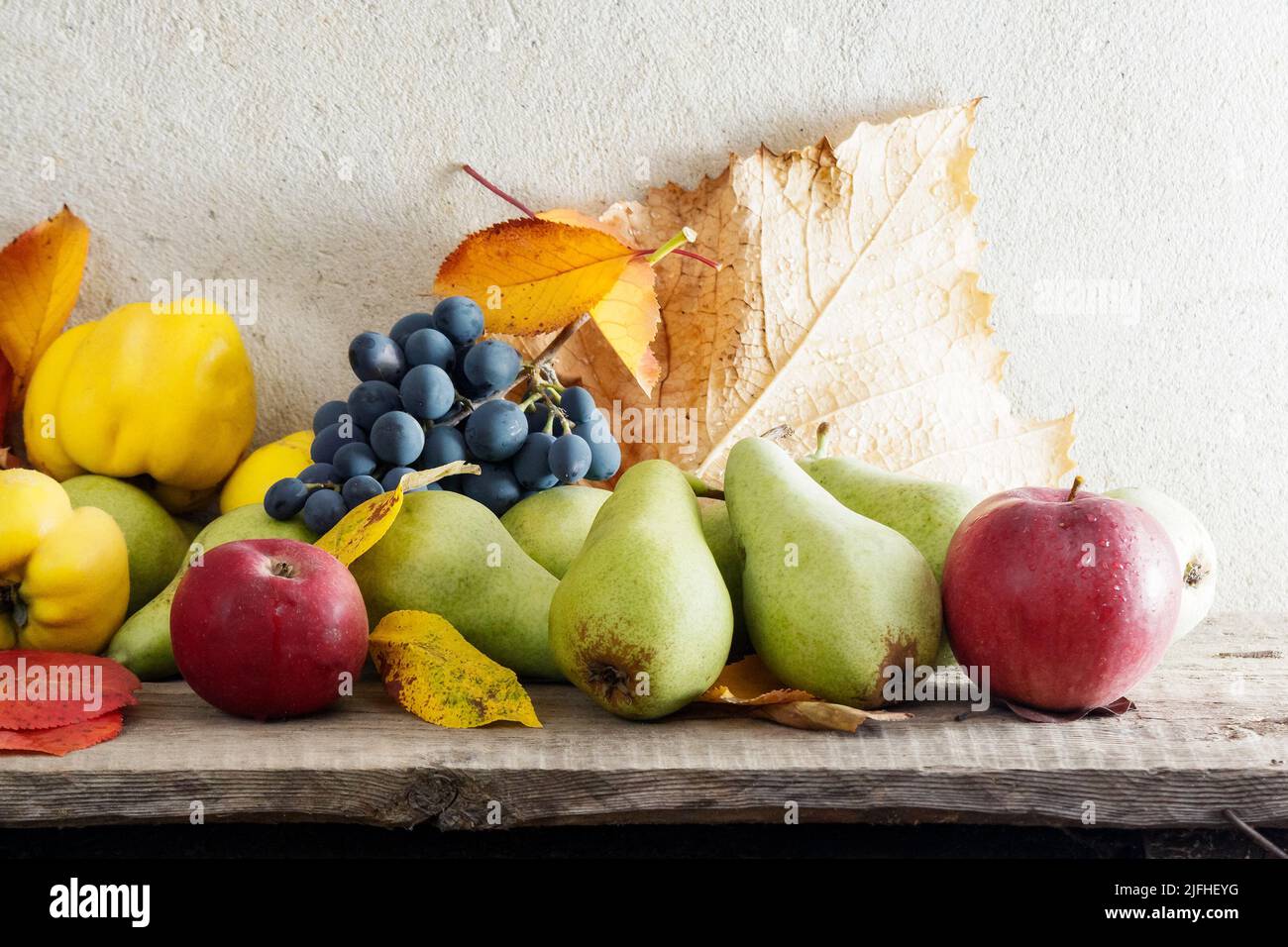autumn crop on the wooden board. lots of ripe fruits. natural grown food and rural lifestyle Stock Photo
