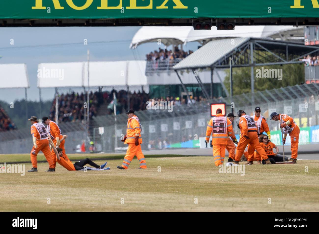 Silverstone, UK. 3rd July 2022,  Silverstone Circuit, Silverstone, Northamptonshire, England: British F1 Grand Prix, Race day: Protestors are removed after running onto the track on the opening lap Credit: Action Plus Sports Images/Alamy Live News Stock Photo