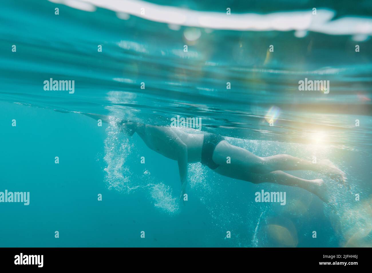 Sporty man swims fast in the sea Stock Photo