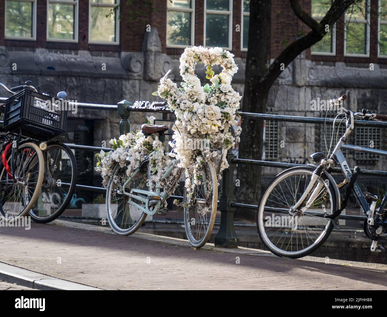 Decorated bicycle on Singel Canal in Amsterdam Stock Photo