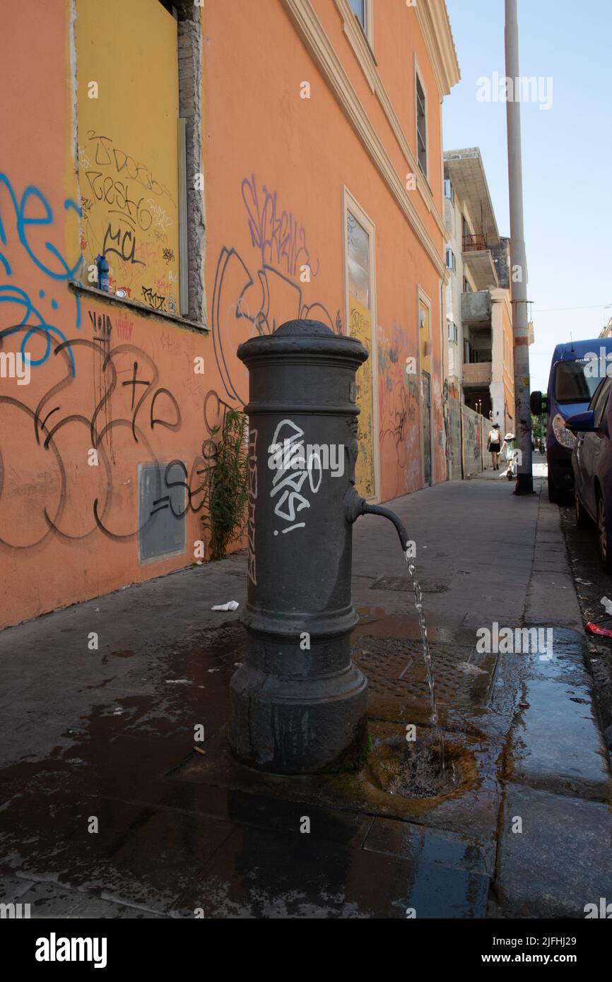 Rome, Italy, July 3th, 2022: A street faucet in the streets of San Lorenzo neighborhood in Rome dropping water during this sunday, as extreme temperatures of 37 to 39°C affected the city Stock Photo