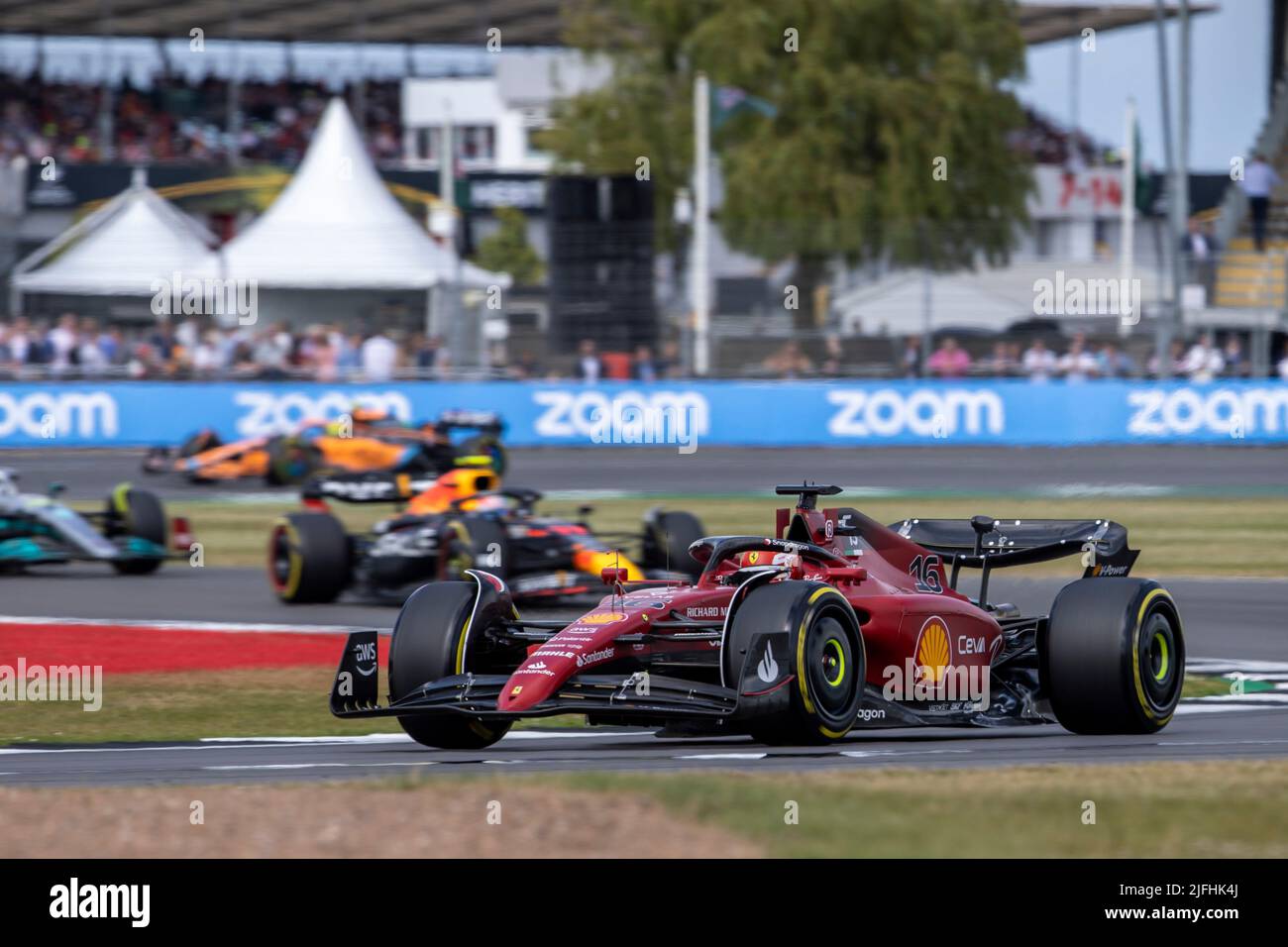 Silverstone, UK. 3rd July 2022, Silverstone Circuit, Silverstone, Northamptonshire, England: British F1 Grand Prix, Race day: Scuderia Ferrari driver Charles Leclerc in his Ferrari F1-75 leads the opening laps of the restart Credit: Action Plus Sports Images/Alamy Live News Stock Photo