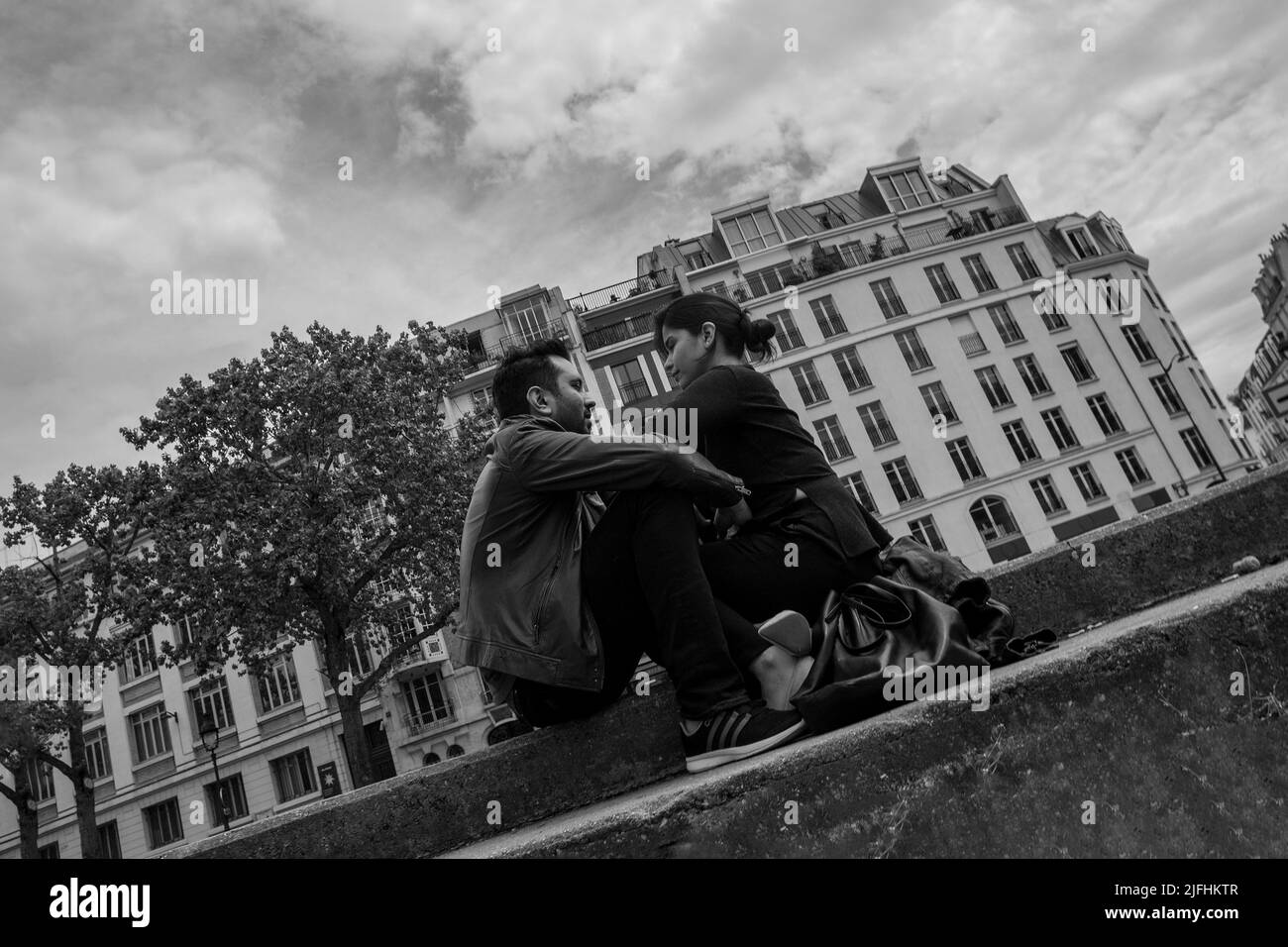 Couple in relationship in Paris (  maybe  iran nationality) - b&w stylized  and declined  photo. Next to Canal Saint-Martin ( as in movie Amelie) Stock Photo