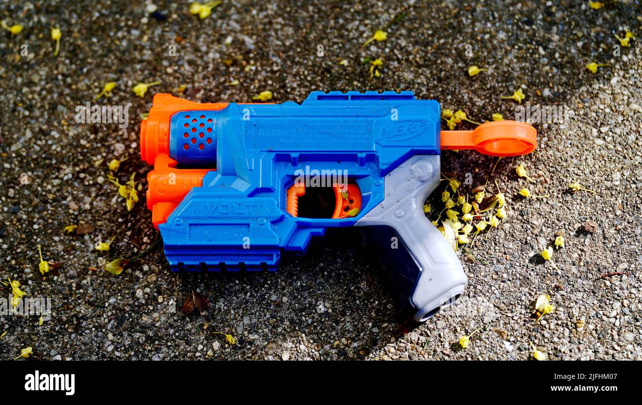 A top view of a toy Nerf gun on the ground Stock Photo