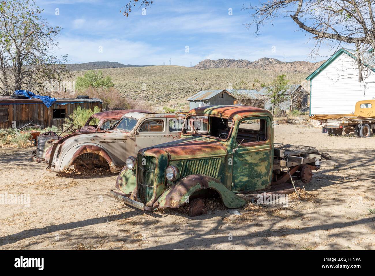 Benton hot Springs, USA - June 3, 2022: old vintage rusty car wrecks at an old abandoned farm in USA Stock Photo