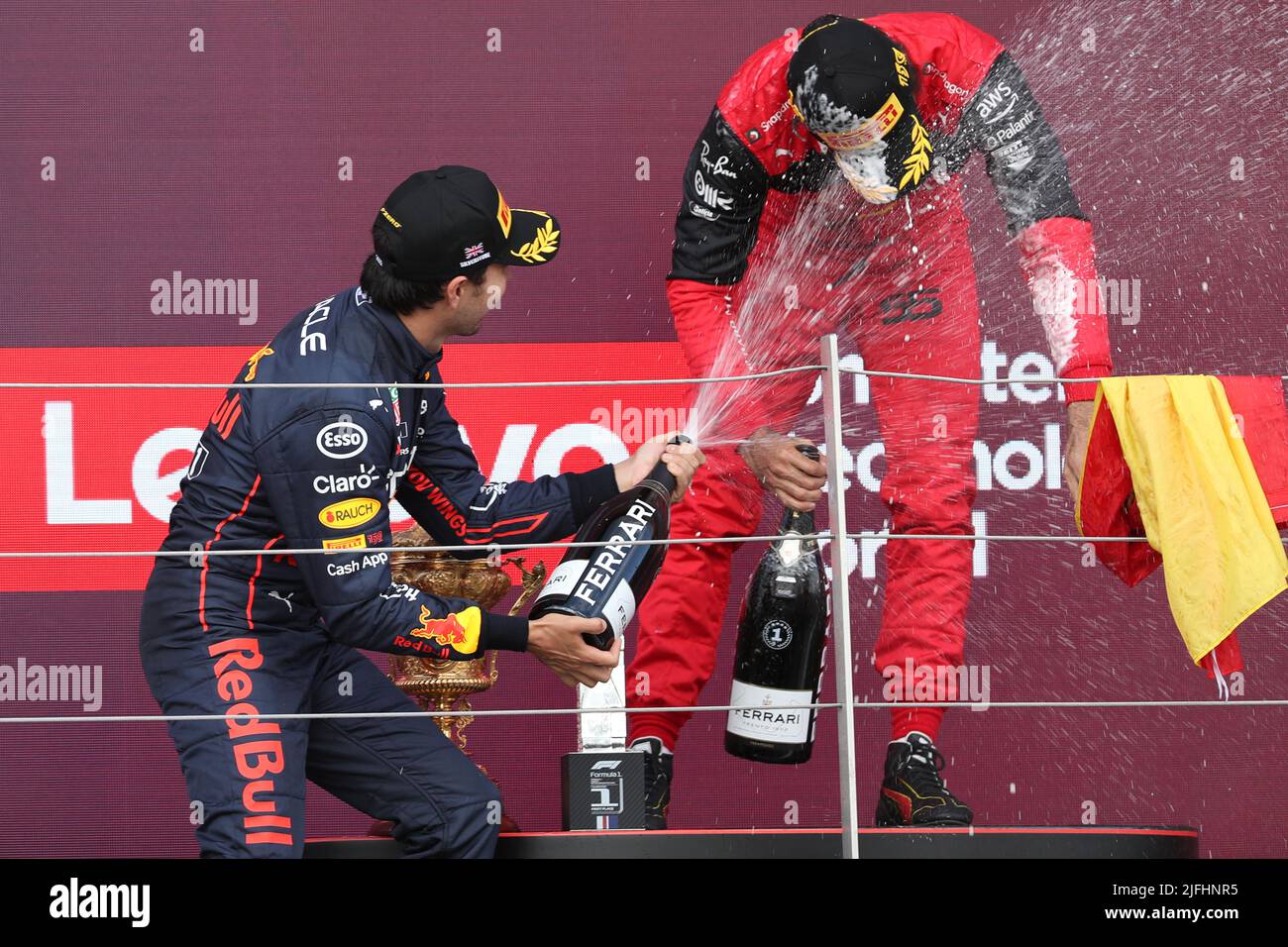 Silverstone, UK. 3rd July 2022,  Silverstone Circuit, Silverstone, Northamptonshire, England: British F1 Grand Prix, Race day: Oracle Red Bull Racing, Sergio Perez comes second and celebrates on the podium with winner Scuderia Ferrari, Carlos Sainz Credit: Action Plus Sports Images/Alamy Live News Stock Photo