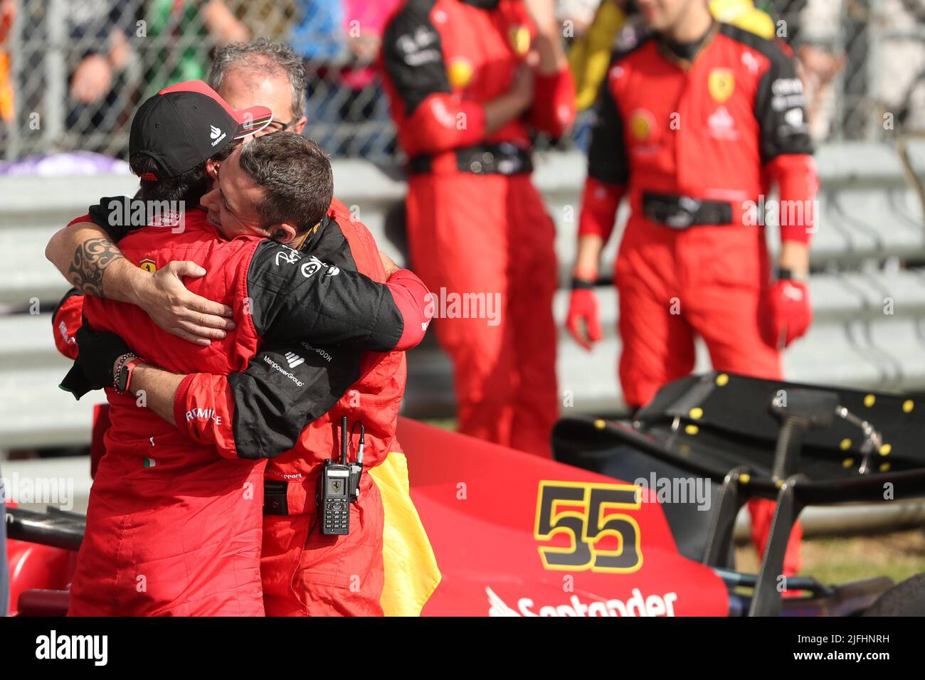 Silverstone, UK. 3rd July 2022,  Silverstone Circuit, Silverstone, Northamptonshire, England: British F1 Grand Prix, Race day: Scuderia Ferrari, Carlos Sainz wins the British GP and is hugged by a team member Credit: Action Plus Sports Images/Alamy Live News Stock Photo